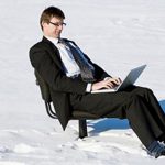 Man Typing in Snow